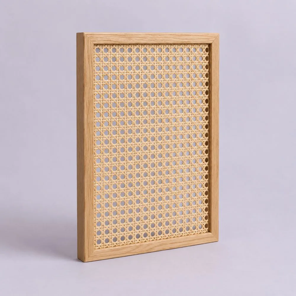 Light oak frame with an open weave natural cane panel, standing upright on a pale lavender backdrop