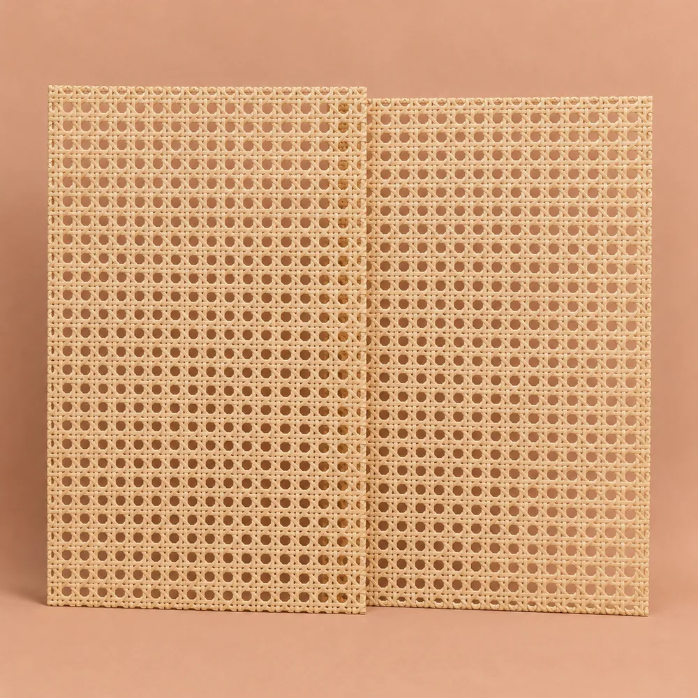 Two matching open weave cane webbing sheets leaning upright side by side on a terracotta backdrop