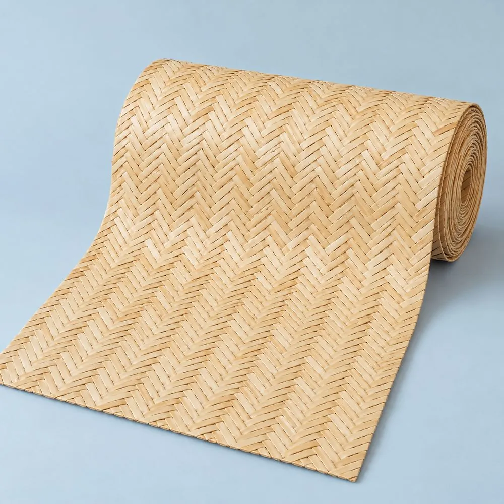 Roll of natural herringbone cane webbing partly unrolled on a pale blue paper backdrop