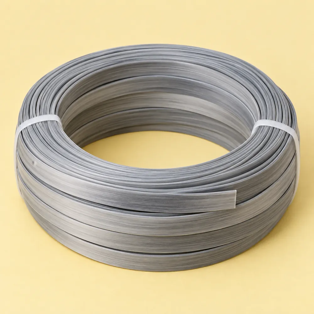 Tied coil of two-tone gradient grey flat PE wicker strip on butter yellow paper