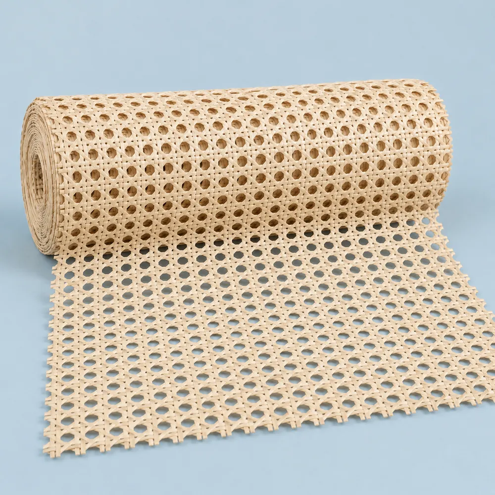 Roll of semi-bleached open weave cane webbing in a pale cream tone, partly unrolled on a dusty blue backdrop