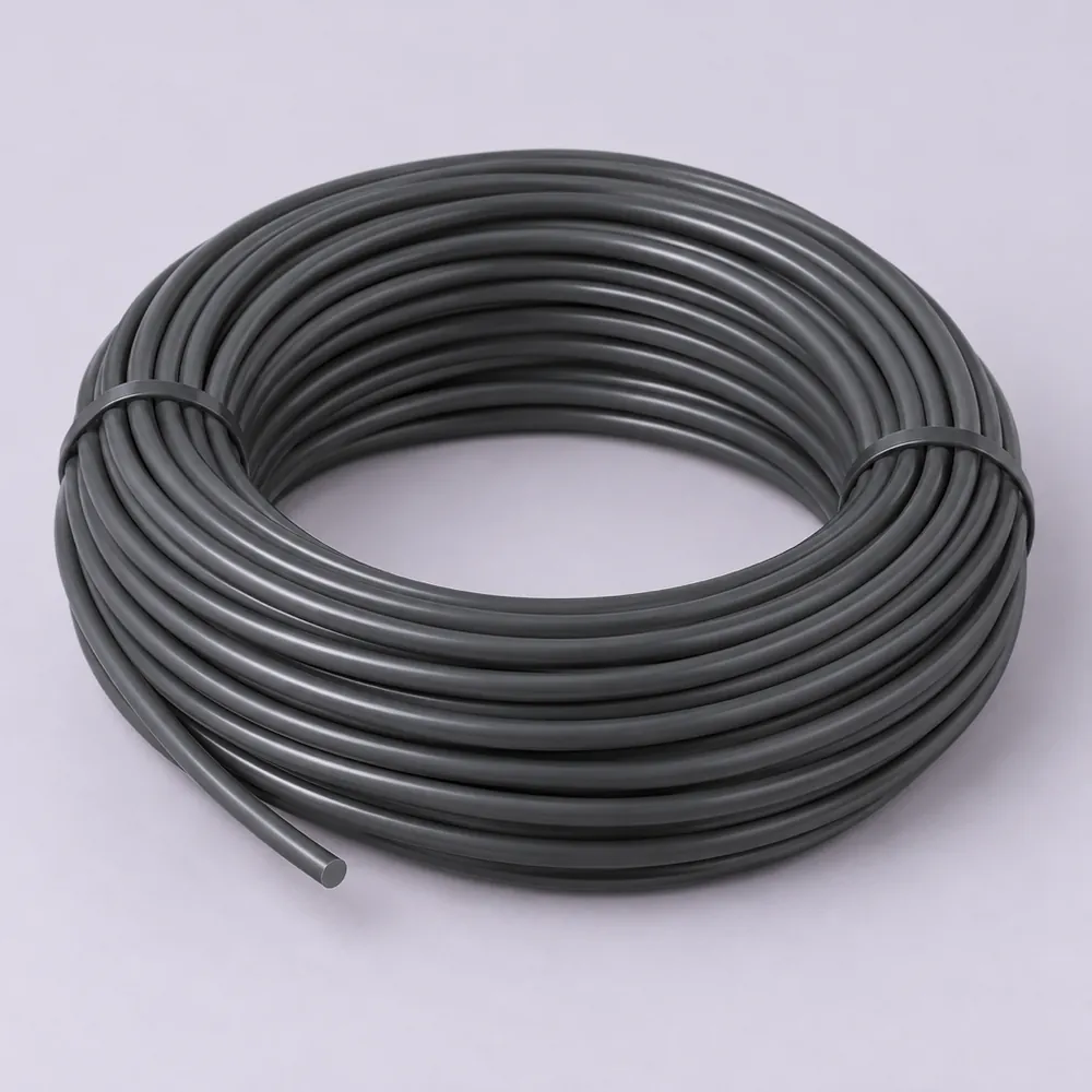 Tied coil of smooth dark grey round PE wicker strand on pale lavender paper